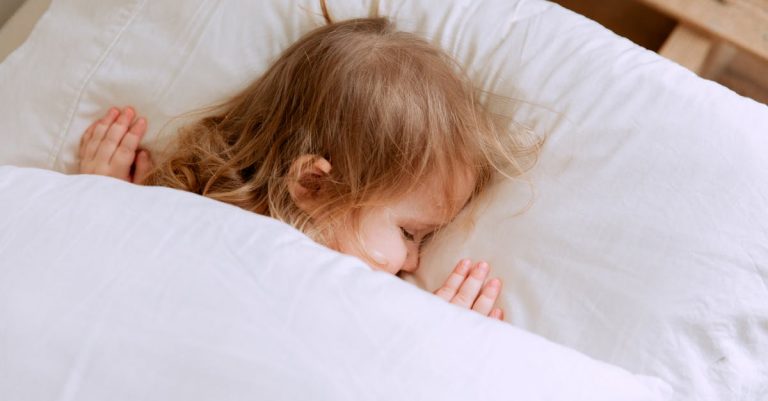 Photo Of Child Laying On Bed